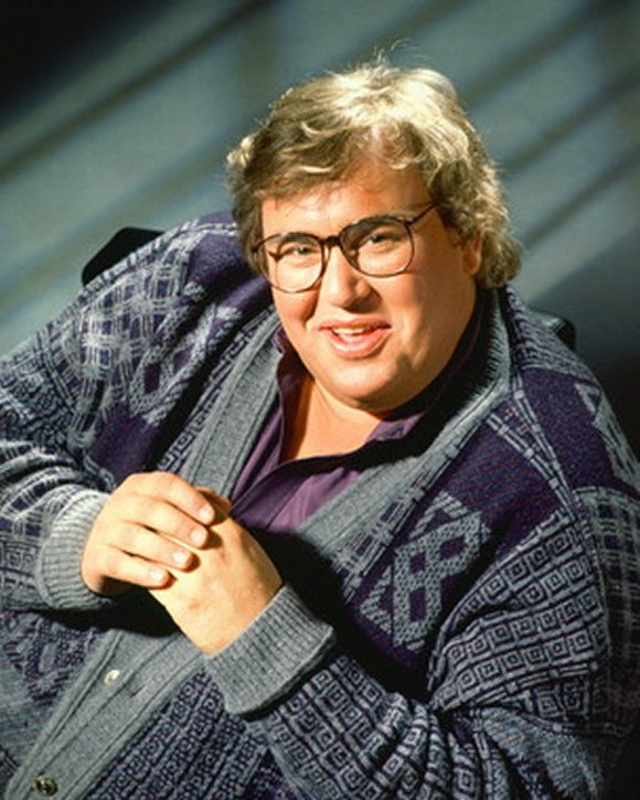 John Candy's inimitable style in a fashionable cardigan.