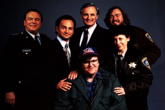 The main cast of Canadian Bacon and the director Michael Moore.