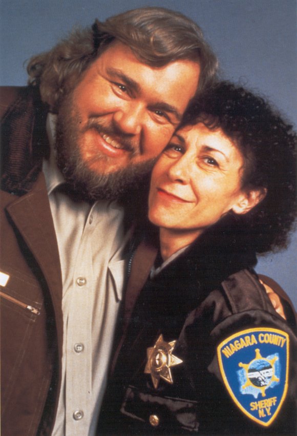 A promotional picture for Canadian Bacon, with Rhea Perlman.